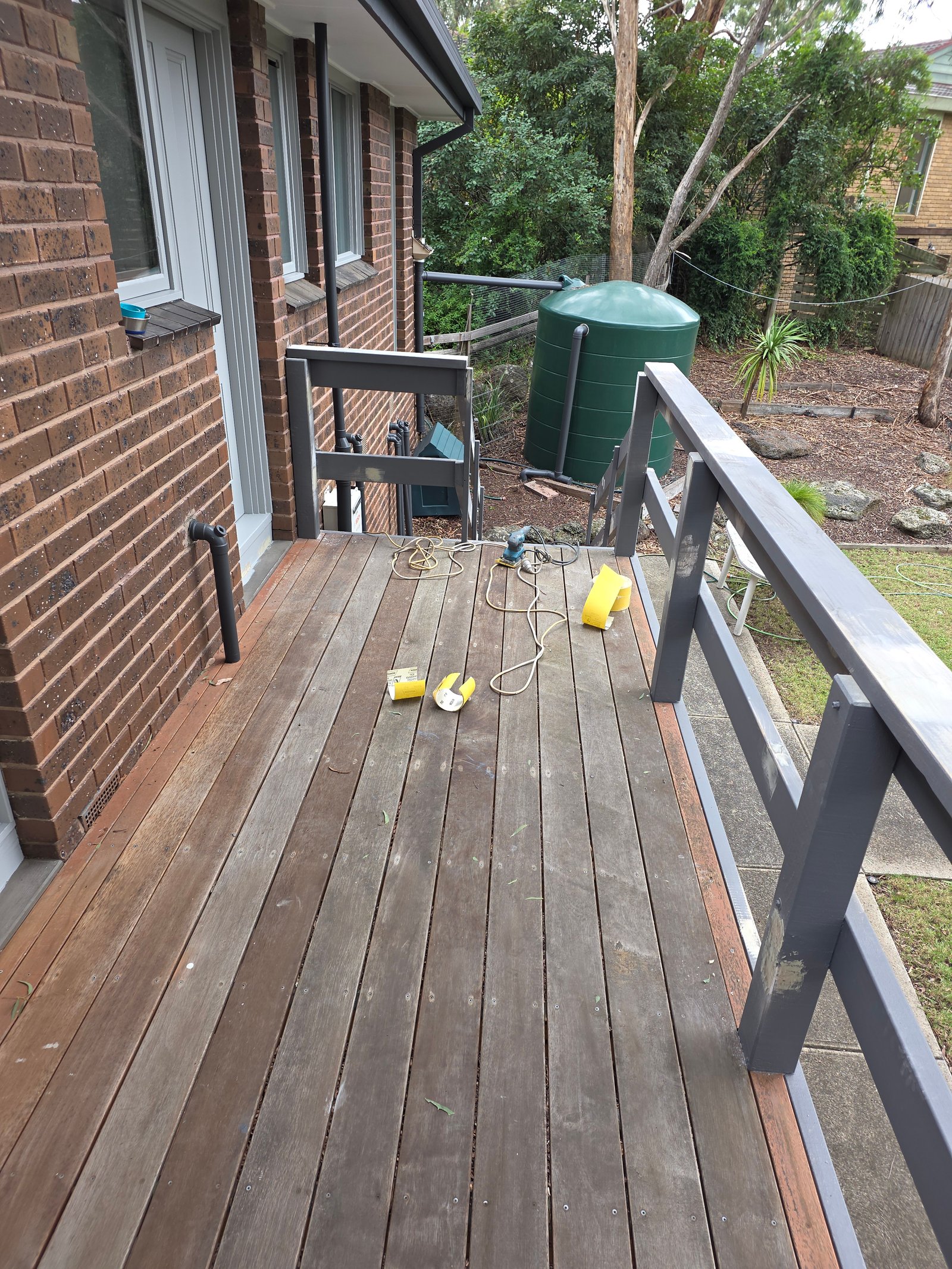 Before decking makeover photo showing a weathered timber deck surface