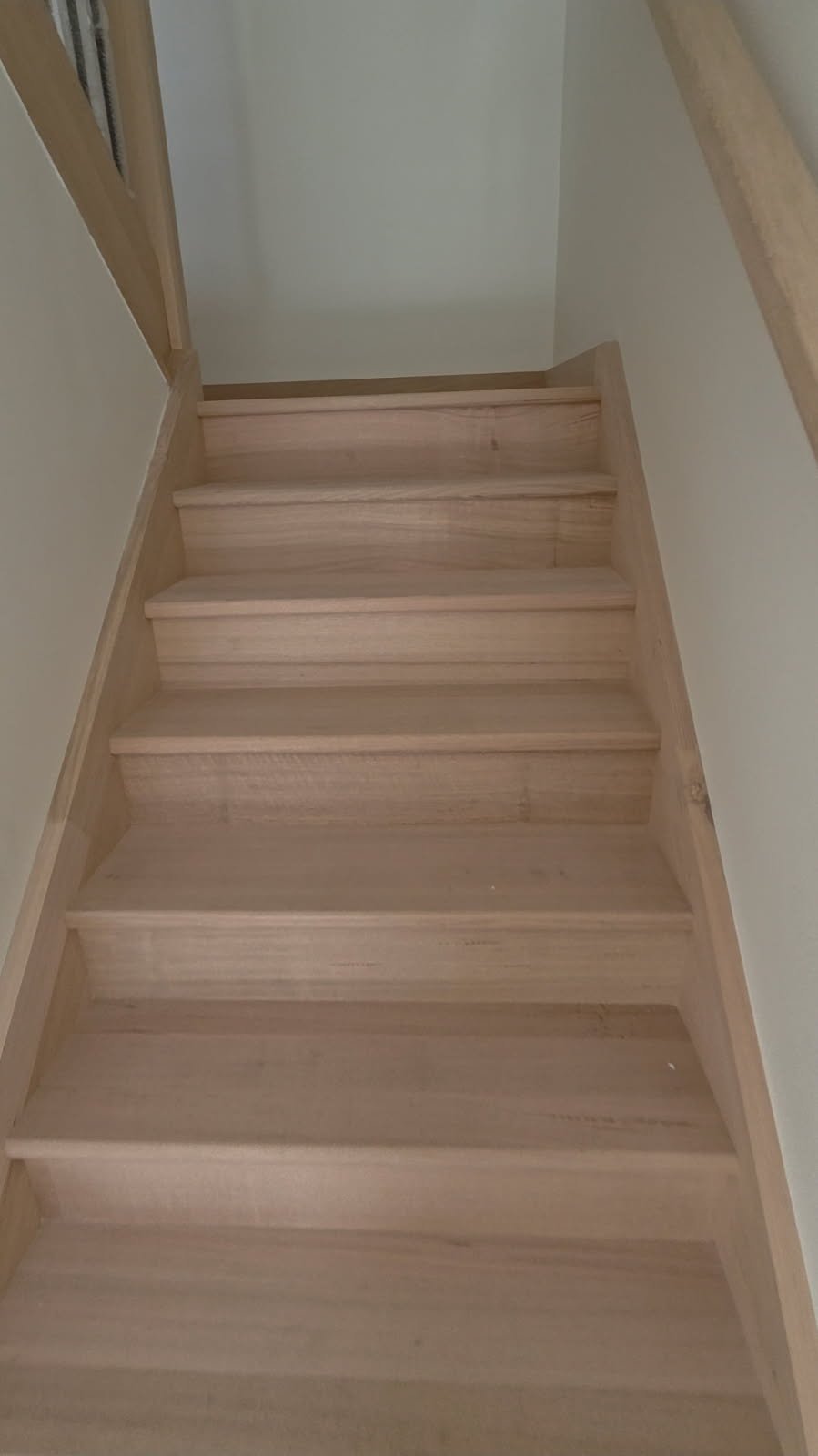 Before staircase timber finish photo showing pale raw timber stairs before staining and finishing